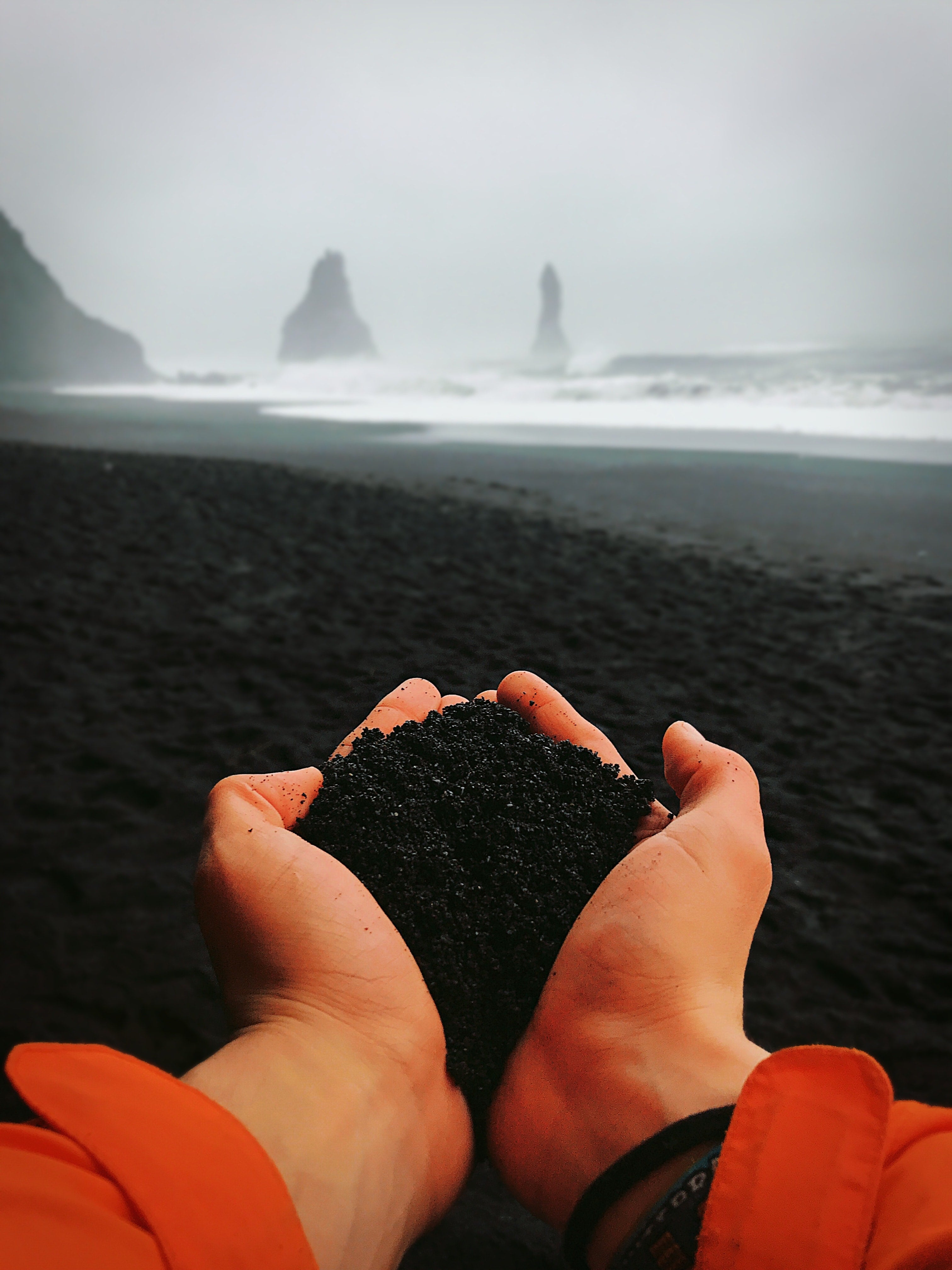 Person's hands holding charcoal
