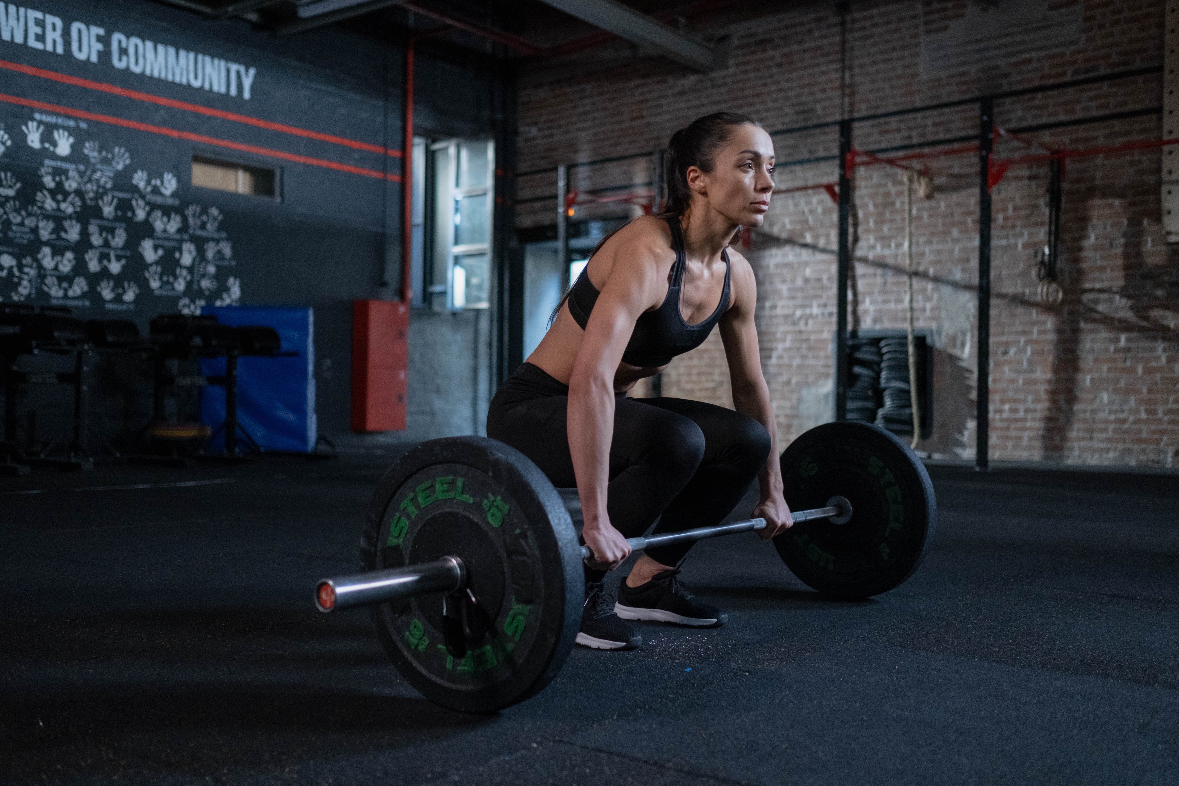 Muscular woman lifting weights at the gym