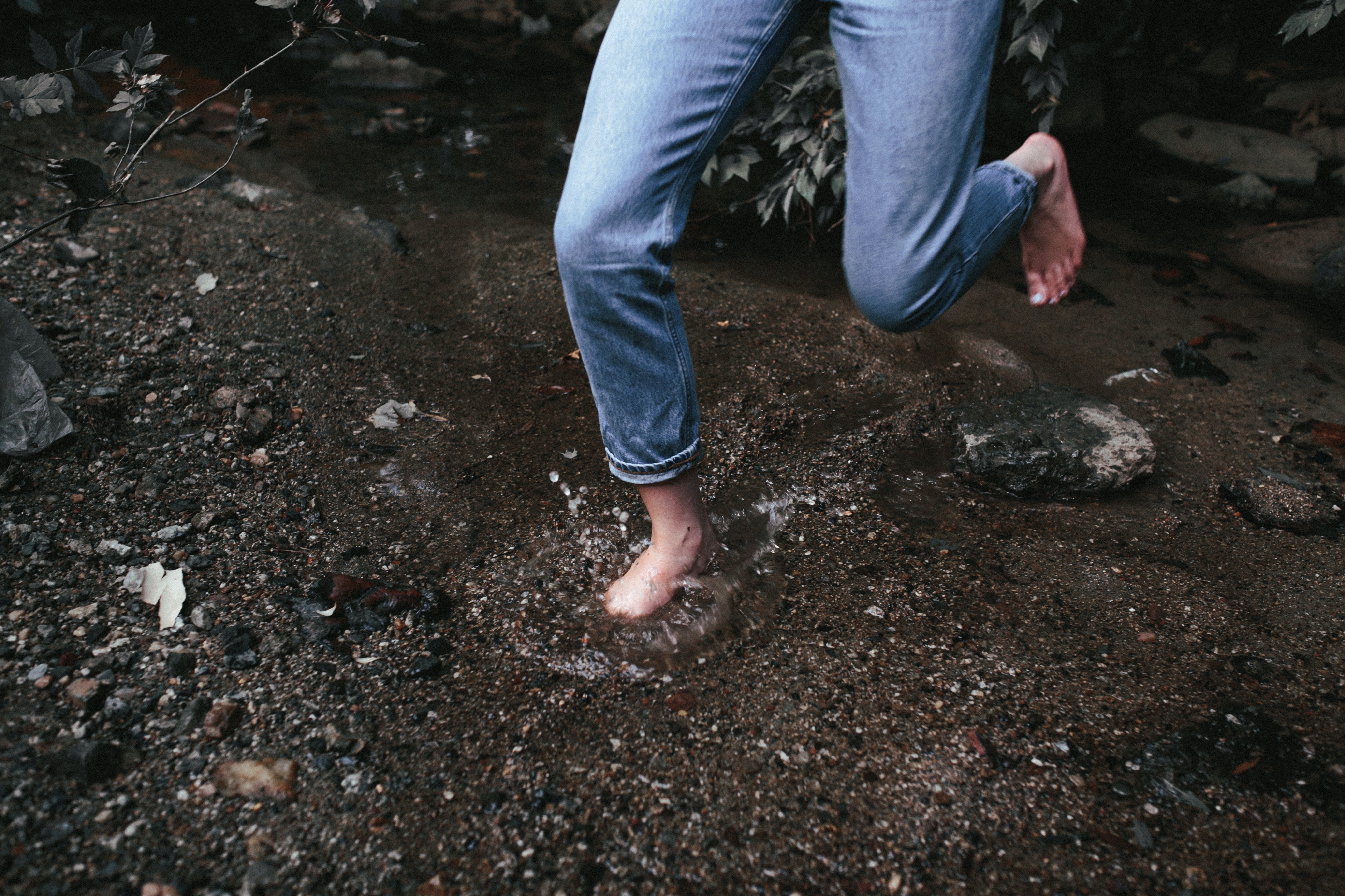 Person running in muddy puddle