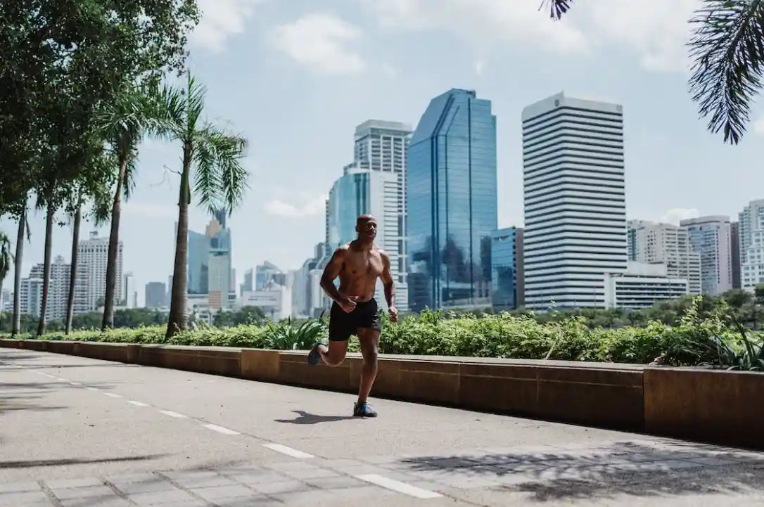 Athletic man running through city
