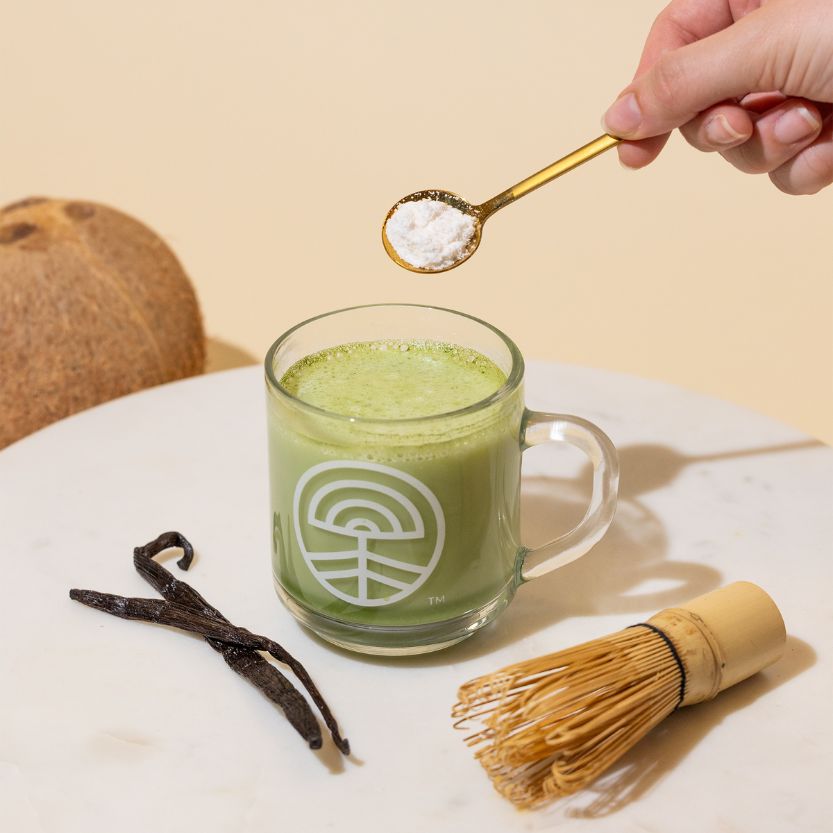 Matcha in a glass mug with vanilla beans