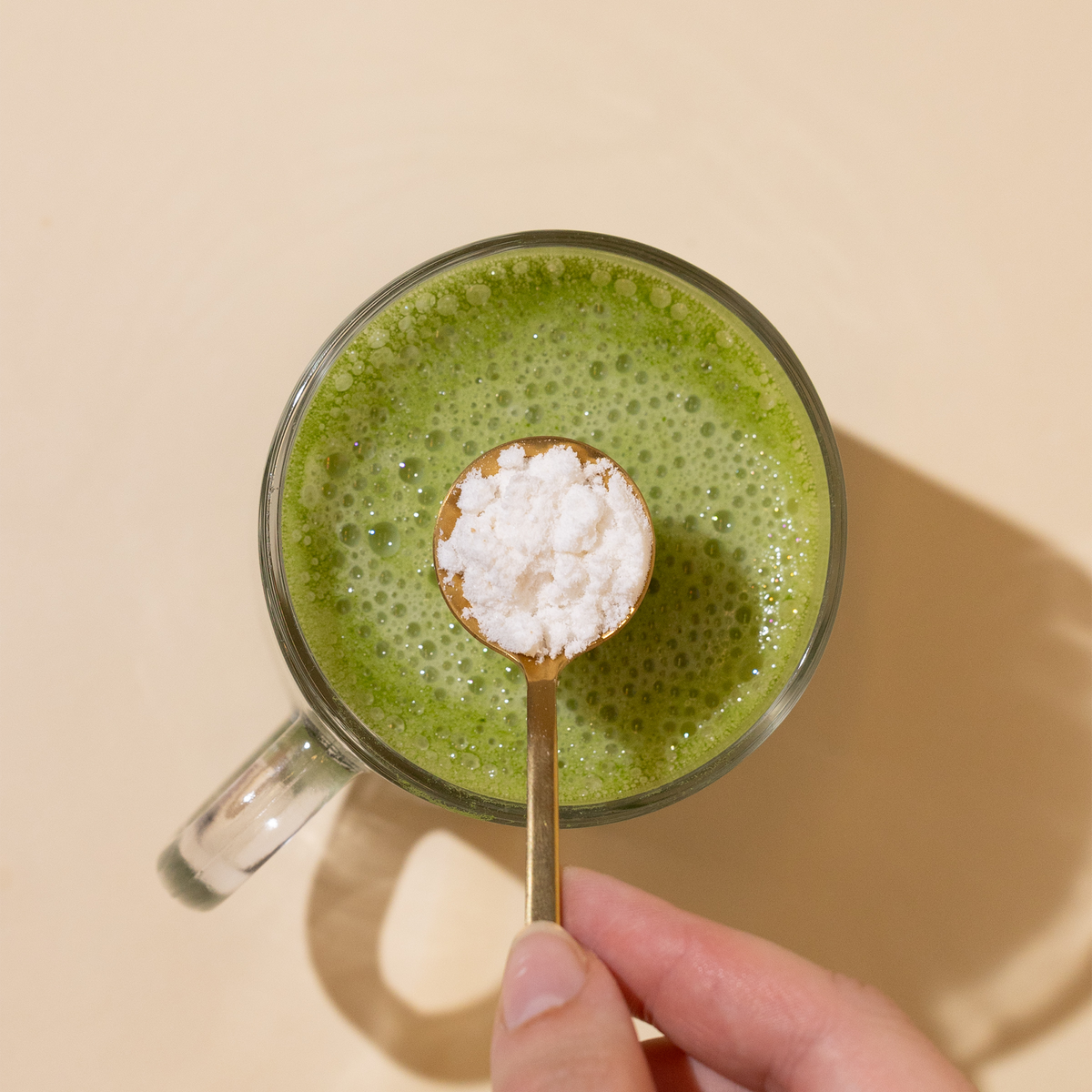Spoonful of Nootropic Creamer Mix over Matcha