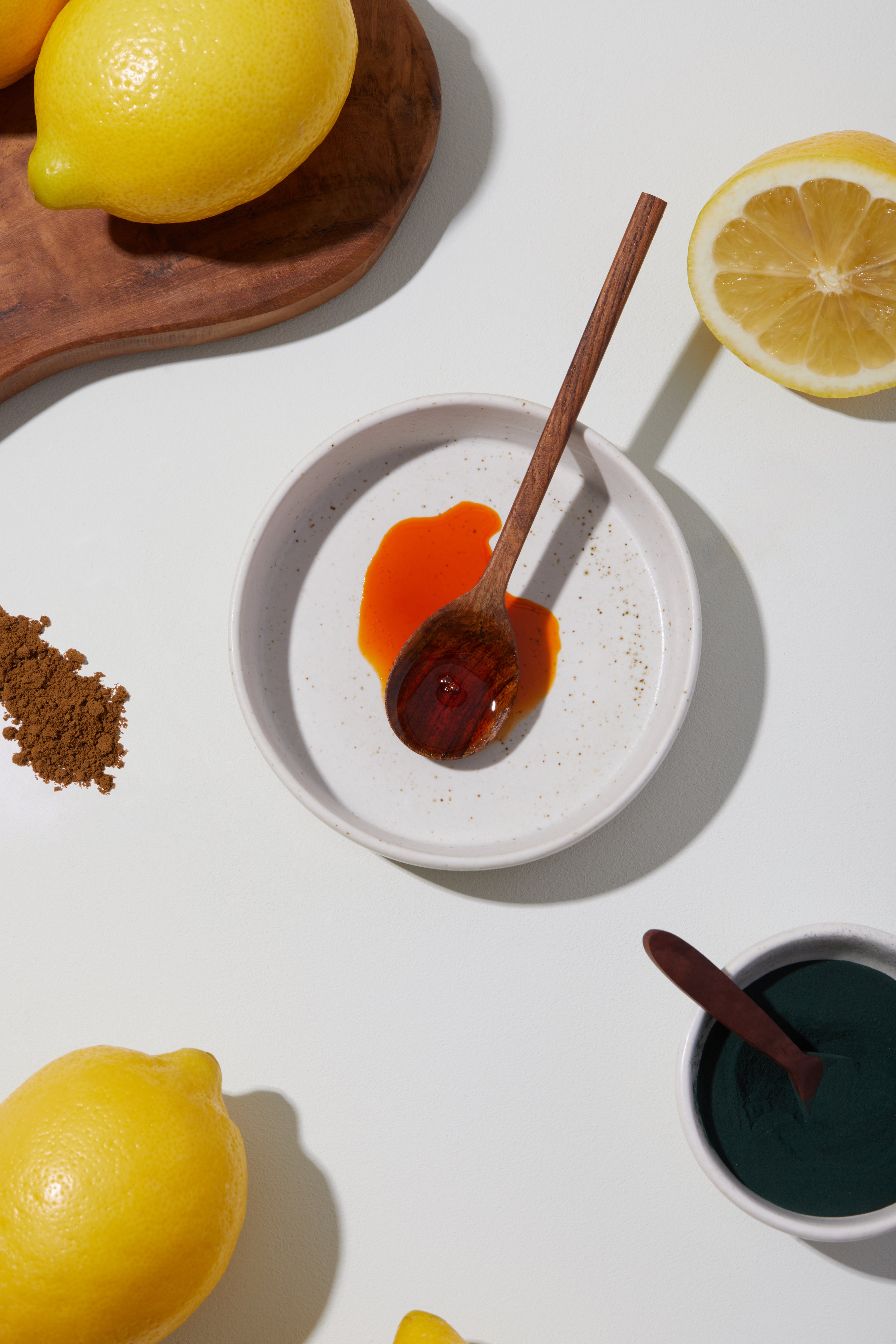The Cymbiotika liquid omega supplement in a bowl surrounded by ingredients