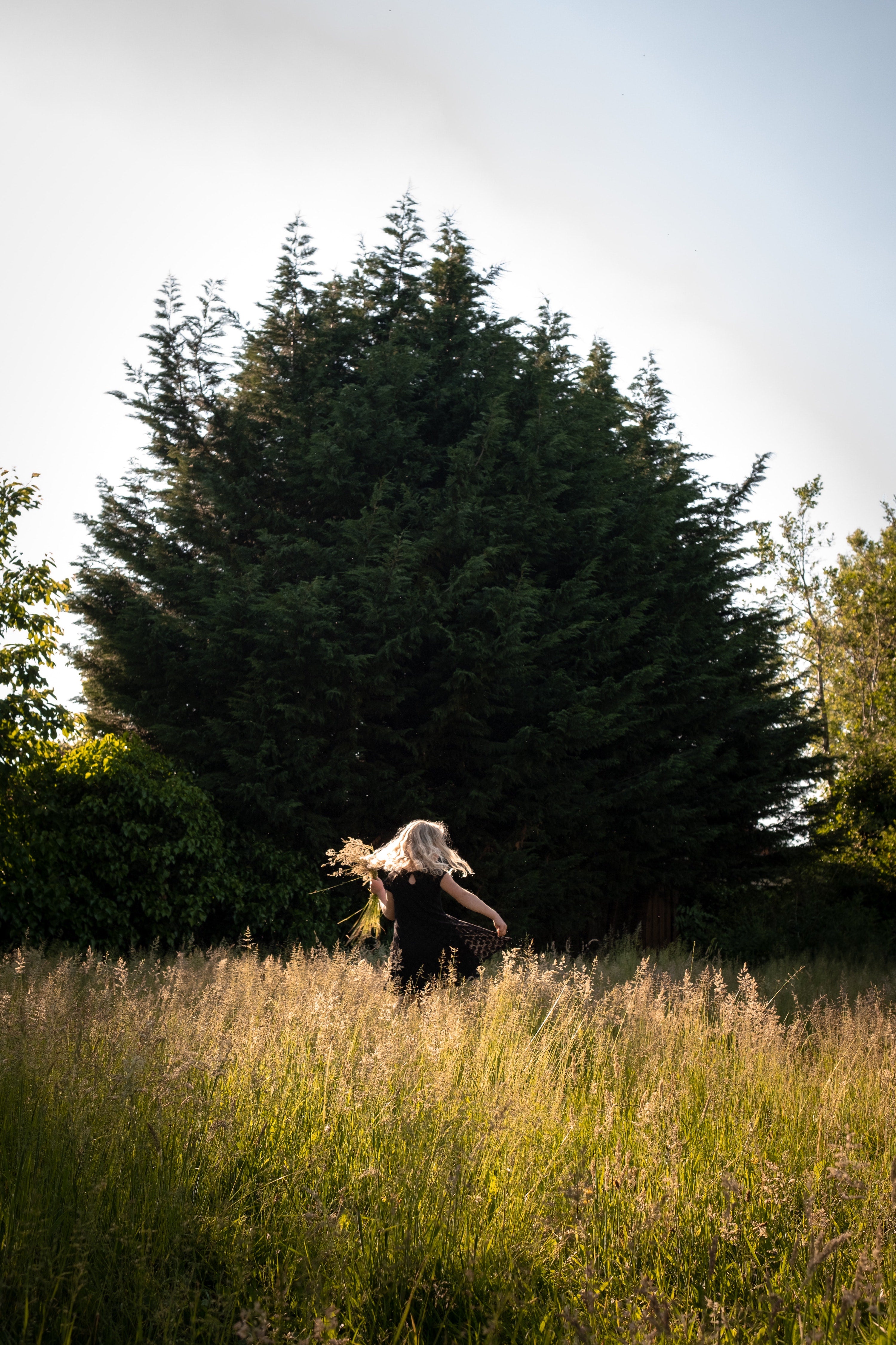 Woman joyfully skipping in meadow