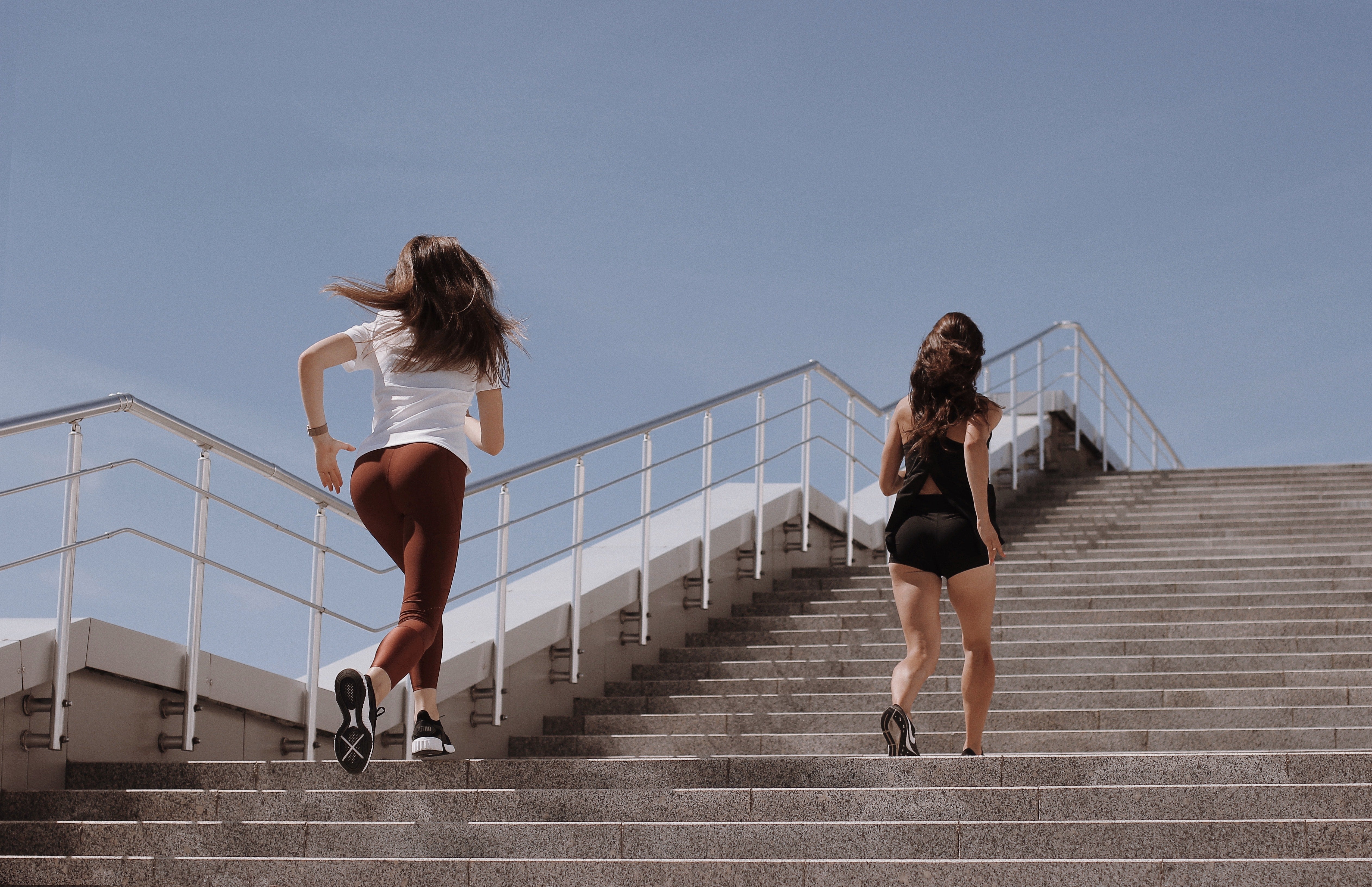 Two women running up stairs