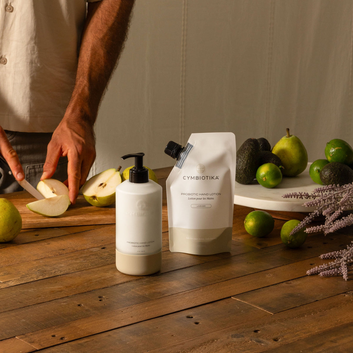 Probiotic Hand Lotion Kit Next to Pear being Cut