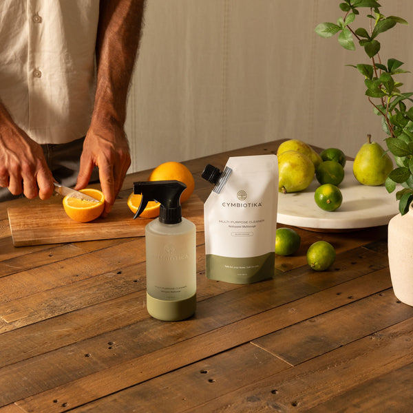 Multi-Purpose Cleaner Bottle on Counter Next to Oranges being Cut